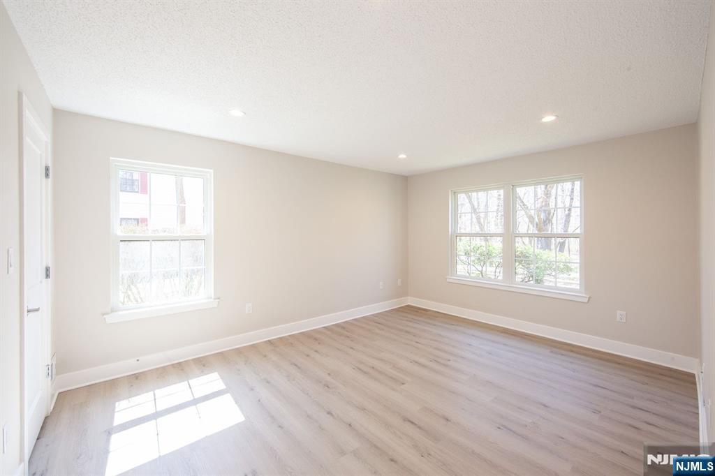 327 Penns Way Bernards, NJ 07920 - Photo 13 of 23 a view of an empty room with wooden floor and a window