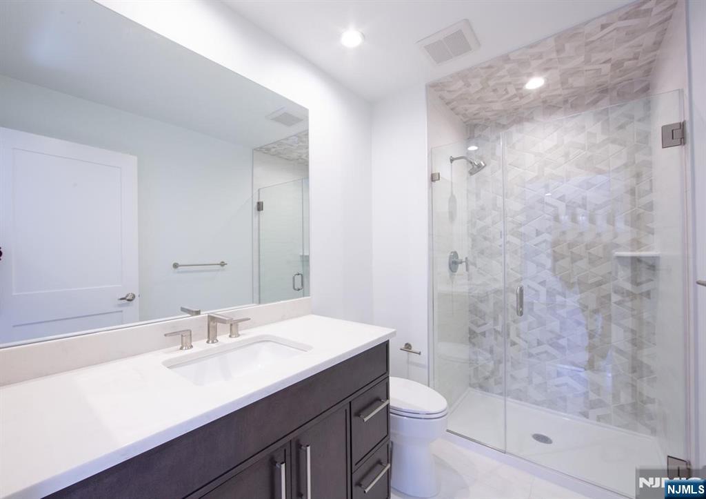 327 Penns Way Bernards, NJ 07920 - Photo 15 of 23 a bathroom with a sink a toilet a shower and a mirror