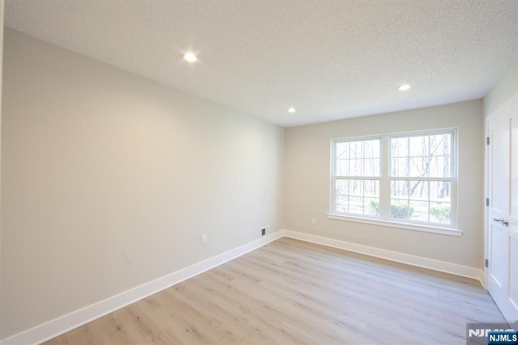 327 Penns Way Bernards, NJ 07920 - Photo 16 of 23 an empty room with wooden floor and windows