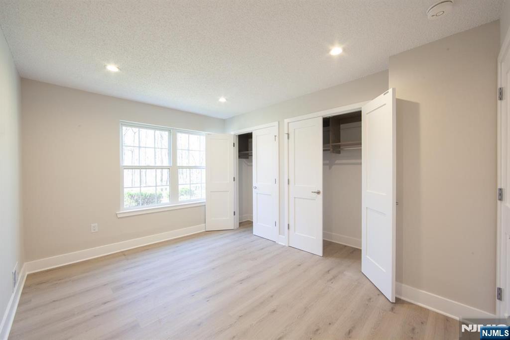 327 Penns Way Bernards, NJ 07920 - Photo 17 of 23 an empty room with wooden floor and windows