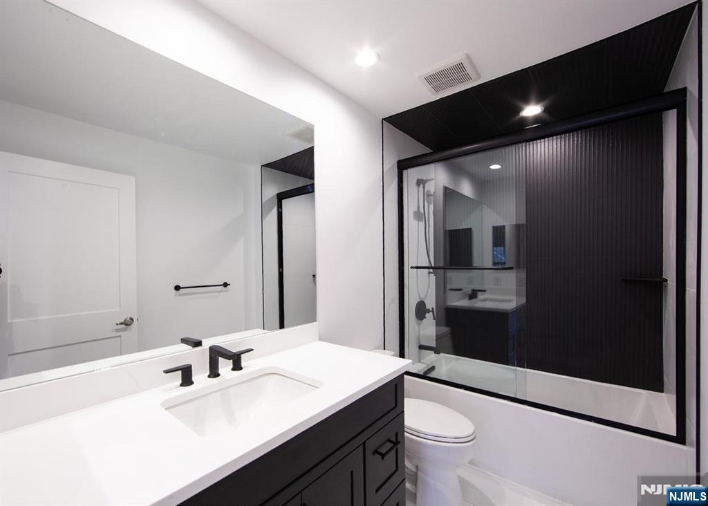 327 Penns Way Bernards, NJ 07920 - Photo 18 of 23 a bathroom with a double vanity sink toilet and shower