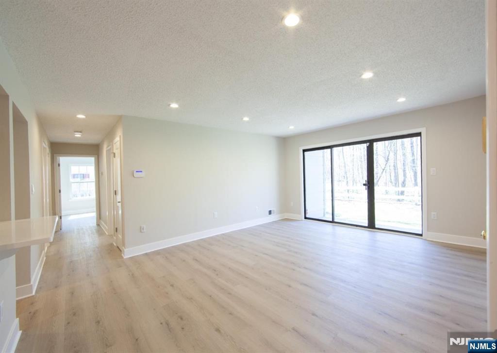 327 Penns Way Bernards, NJ 07920 - Photo 10 of 23 a view of an empty room with wooden floor and a window