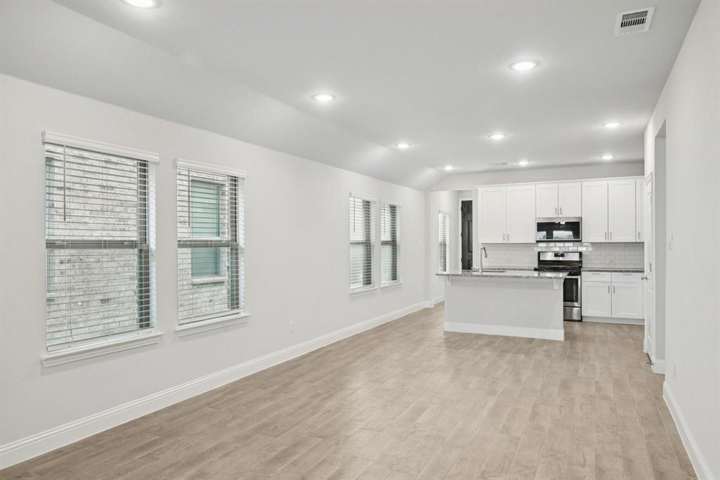 1685 Timpson Drive Forney, TX 75126 - Photo 11 of 36 a view of kitchen with kitchen island stainless steel appliances refrigerator oven and cabinets