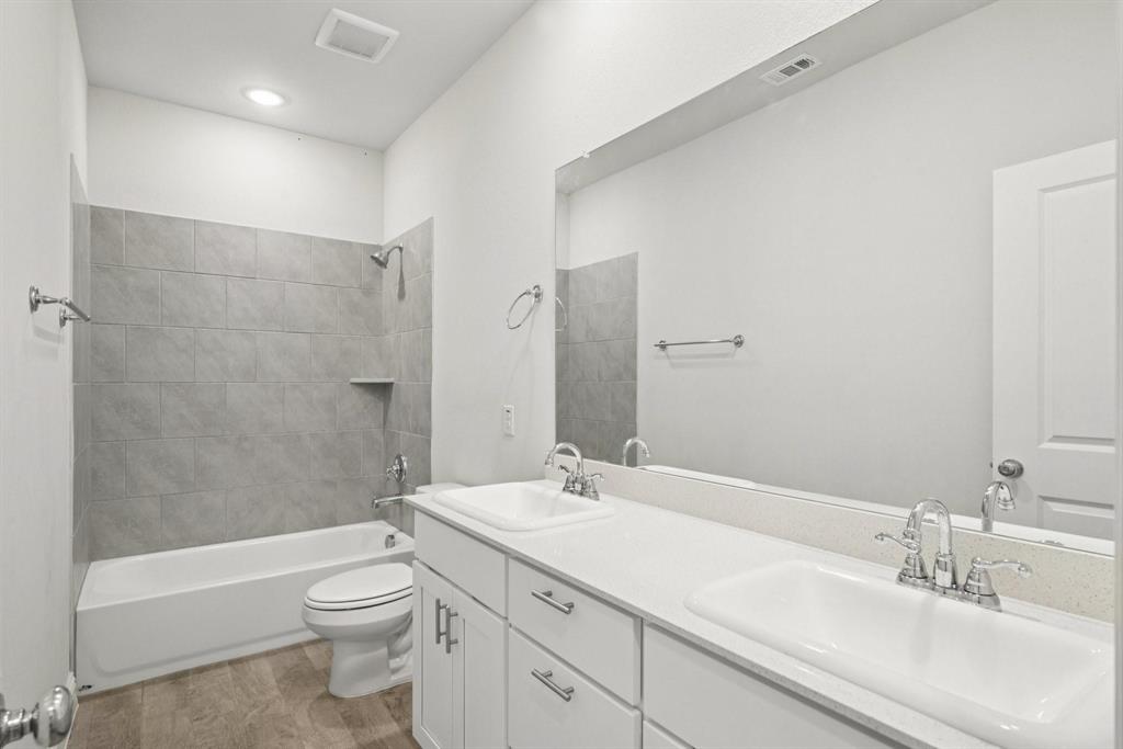 1685 Timpson Drive Forney, TX 75126 - Photo 14 of 36 a bathroom with a sink a toilet and shower