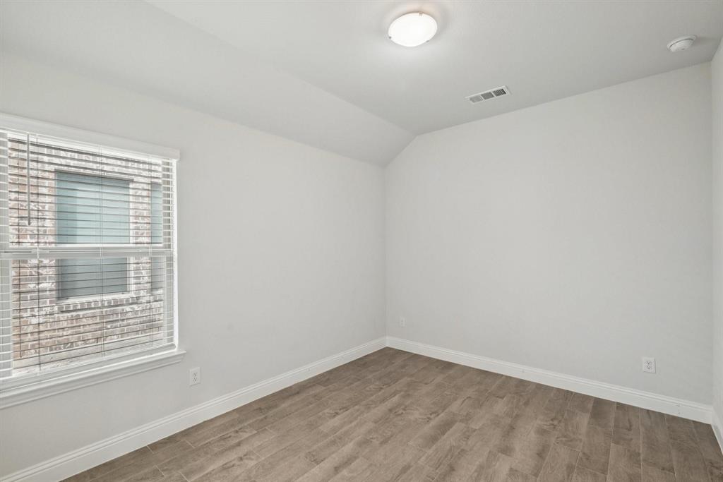 1685 Timpson Drive Forney, TX 75126 - Photo 15 of 36 a view of an empty room with wooden floor and a window