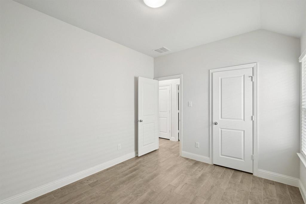 1685 Timpson Drive Forney, TX 75126 - Photo 16 of 36 an empty room with wooden floor