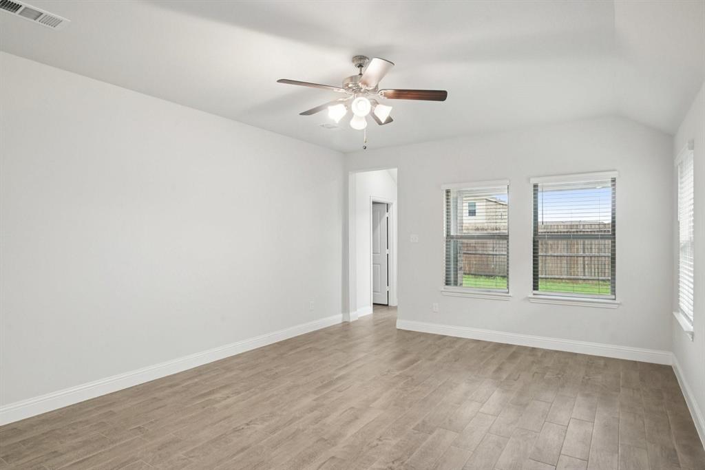 1685 Timpson Drive Forney, TX 75126 - Photo 20 of 36 an empty room with wooden floor fan and windows