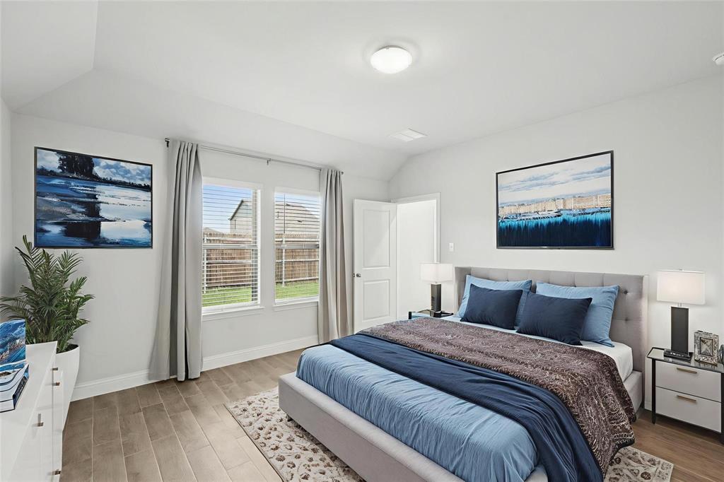 1685 Timpson Drive Forney, TX 75126 - Photo 22 of 36 a bedroom with a large bed and a potted plant