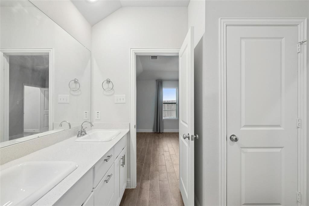 1685 Timpson Drive Forney, TX 75126 - Photo 25 of 36 a spacious bathroom with a double vanity sink and mirror