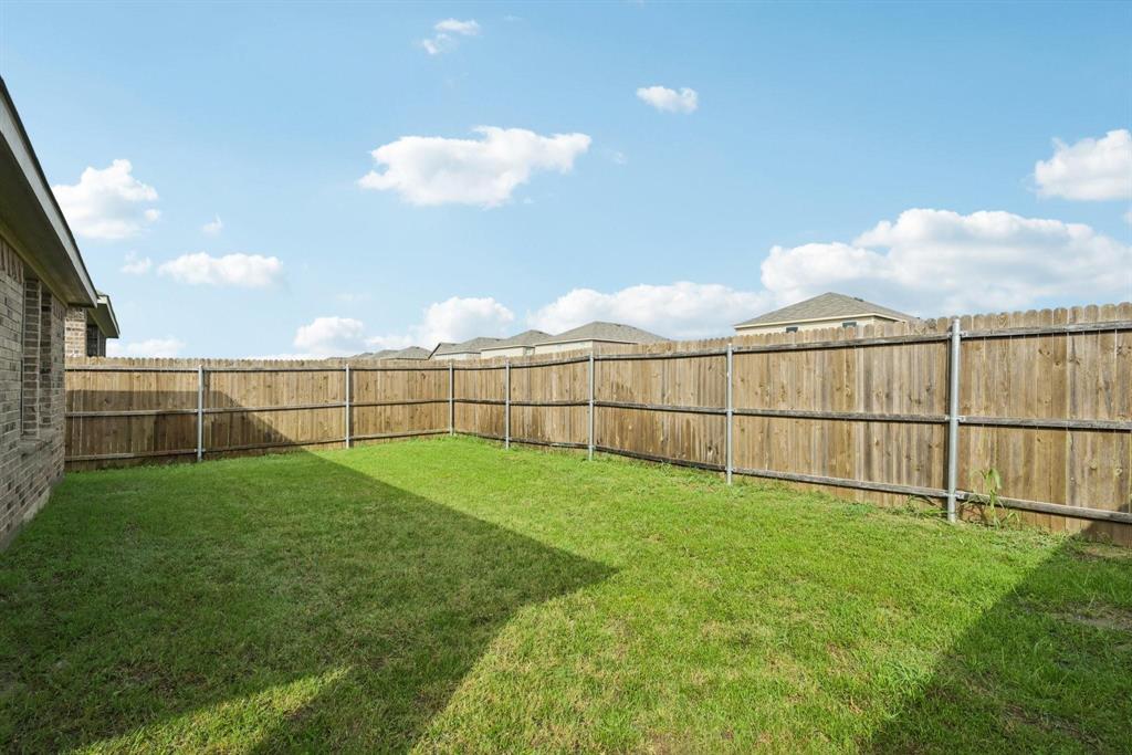 1685 Timpson Drive Forney, TX 75126 - Photo 34 of 36 a view of a backyard with grass & fence