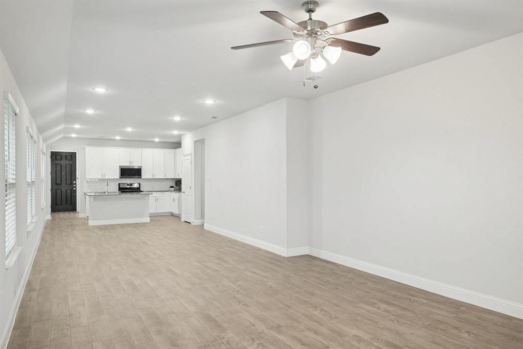 1685 Timpson Drive Forney, TX 75126 - Photo 4 of 36 a view of a kitchen with a sink and a stove