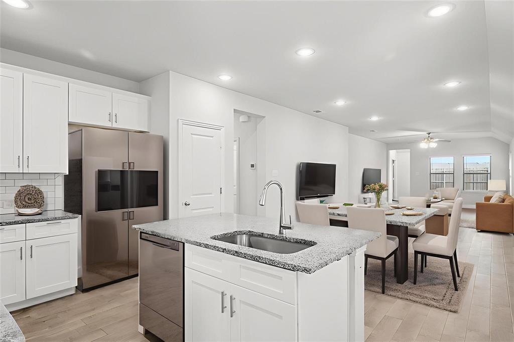 1685 Timpson Drive Forney, TX 75126 - Photo 8 of 36 a kitchen with a sink microwave and refrigerator