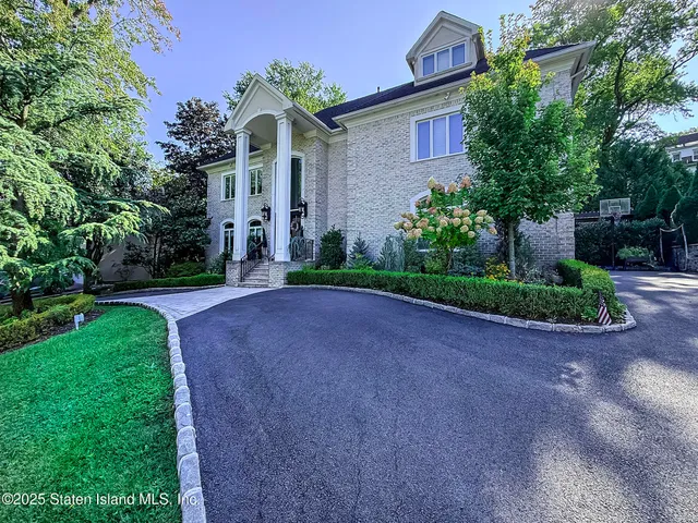 a front view of a house with a yard and a garage