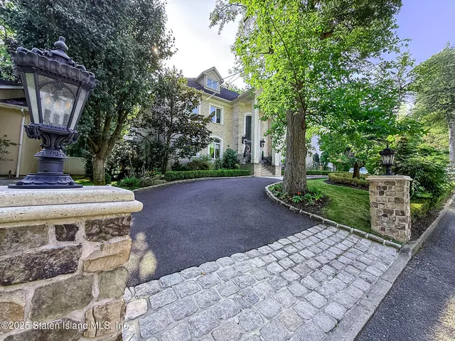 a view of a patio with table and chairs with wooden fence and plants