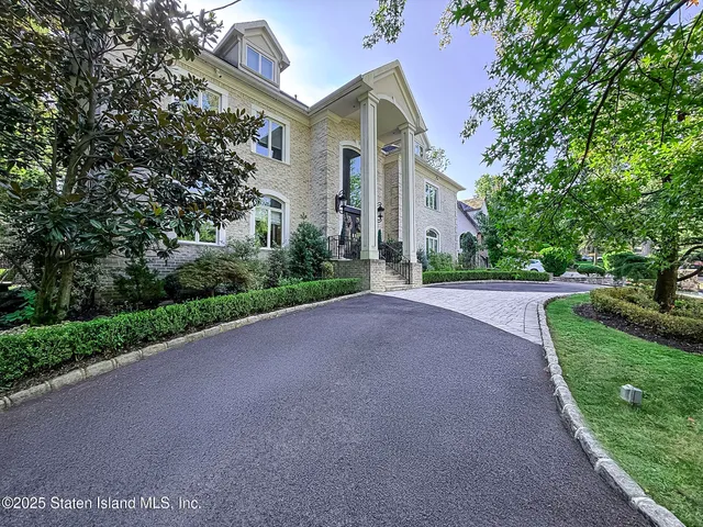 a view of a road with a house in the background