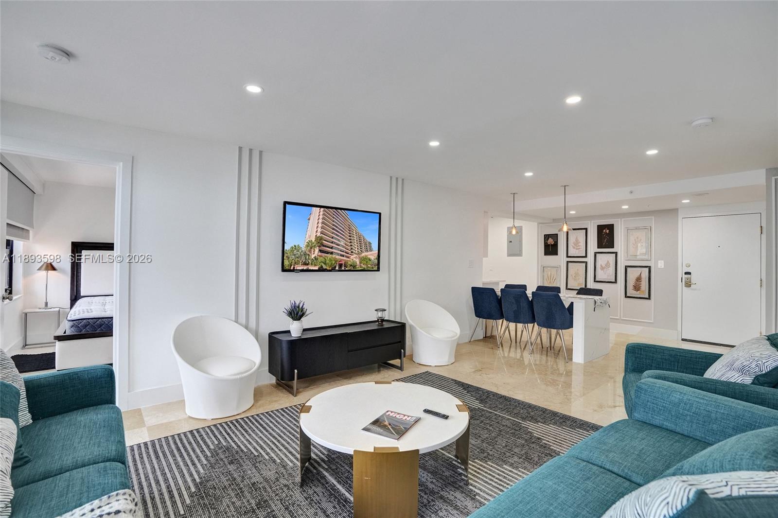 5225 Collins Avenue, Unit 1411 Miami Beach, FL 33140 - Photo 15 of 36 a living room with furniture and a table