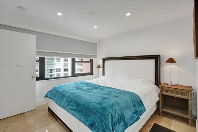 a bedroom with two beds and a large window