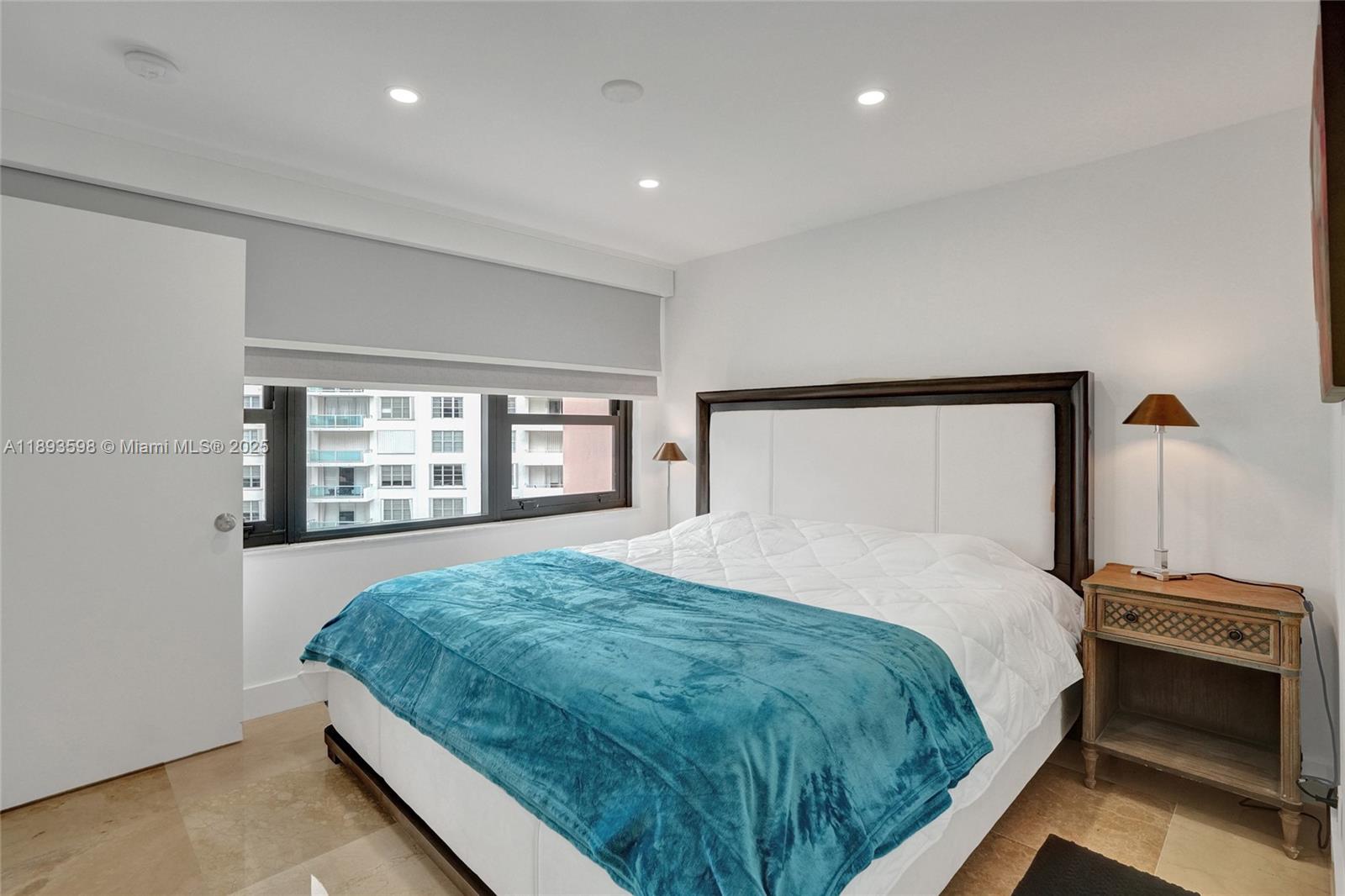 5225 Collins Avenue, Unit 1411 Miami Beach, FL 33140 - Photo 17 of 34 a bedroom with a bed and a window