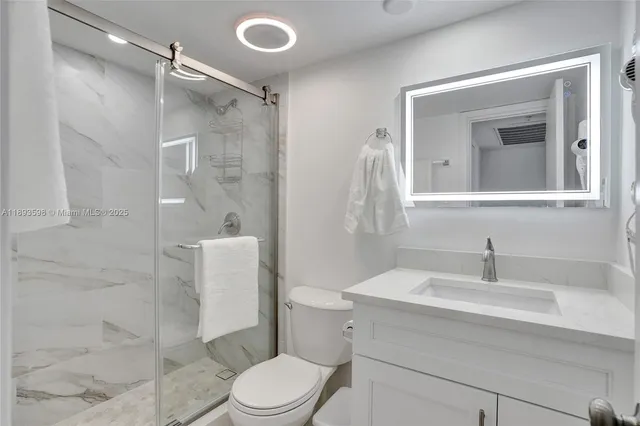 a bedroom with two bed and a painting on the wall