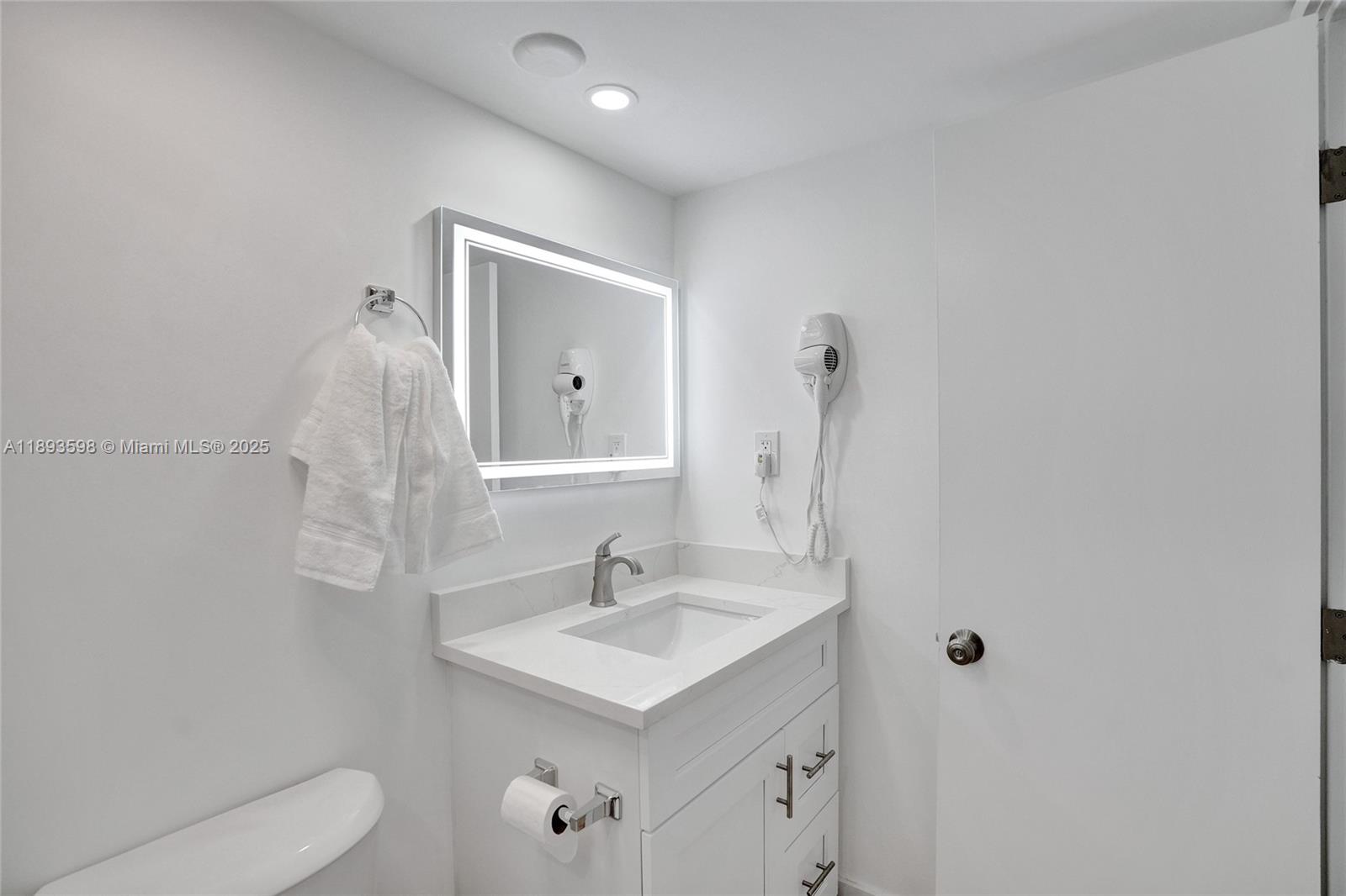 5225 Collins Avenue, Unit 1411 Miami Beach, FL 33140 - Photo 20 of 34 a bathroom with a sink toilet and shower