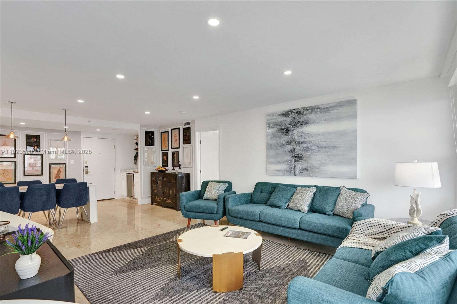 5225 Collins Avenue, Unit 1411 Miami Beach, FL 33140 - Photo 2 of 34 a living room with furniture and wooden floor