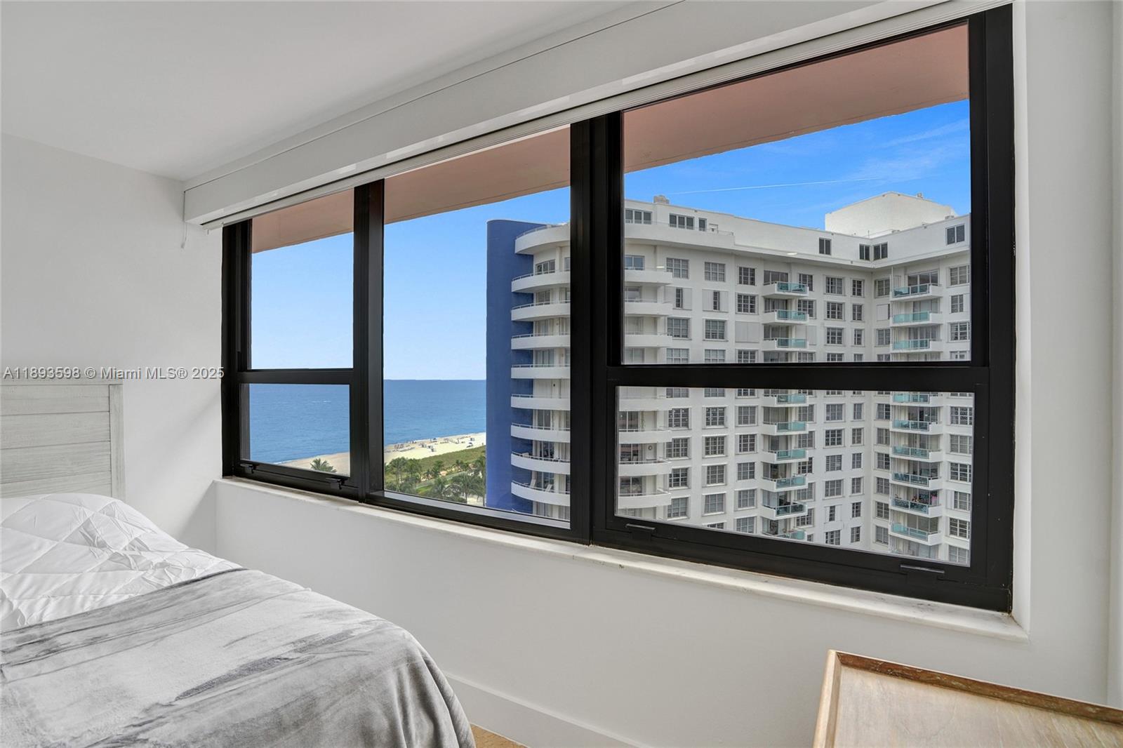 5225 Collins Avenue, Unit 1411 Miami Beach, FL 33140 - Photo 23 of 34 a bedroom with a bed and a large window