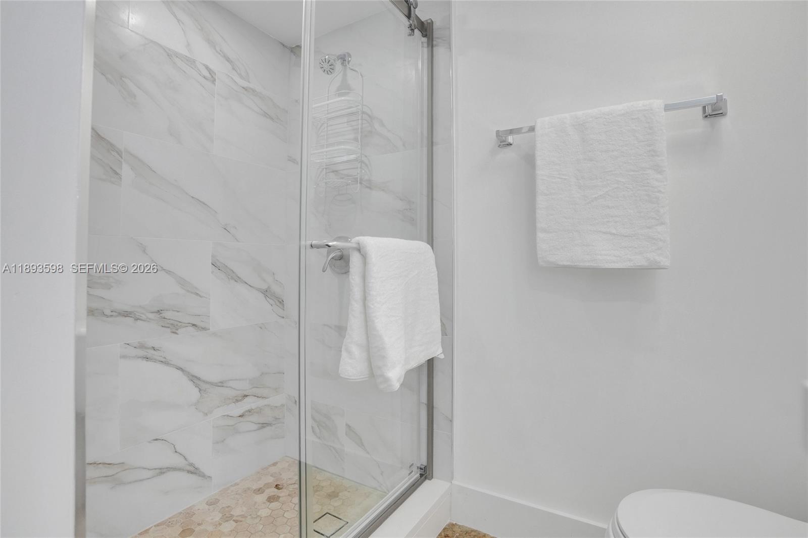 5225 Collins Avenue, Unit 1411 Miami Beach, FL 33140 - Photo 27 of 36 a bathroom with a shower and toilet