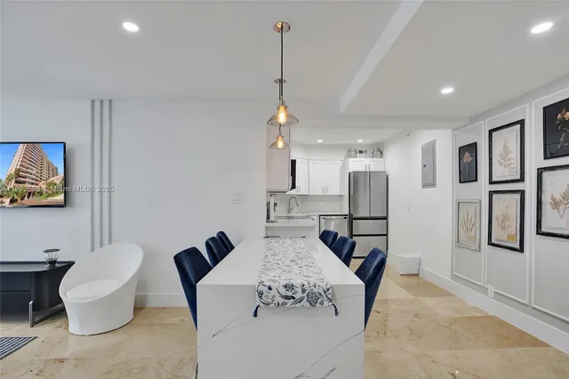 a living room with furniture a chandelier and a dining table
