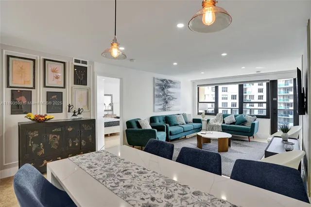 a living room with furniture a rug and a large window