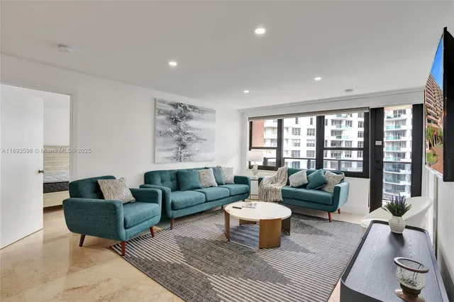 a living room with furniture a rug and a large window