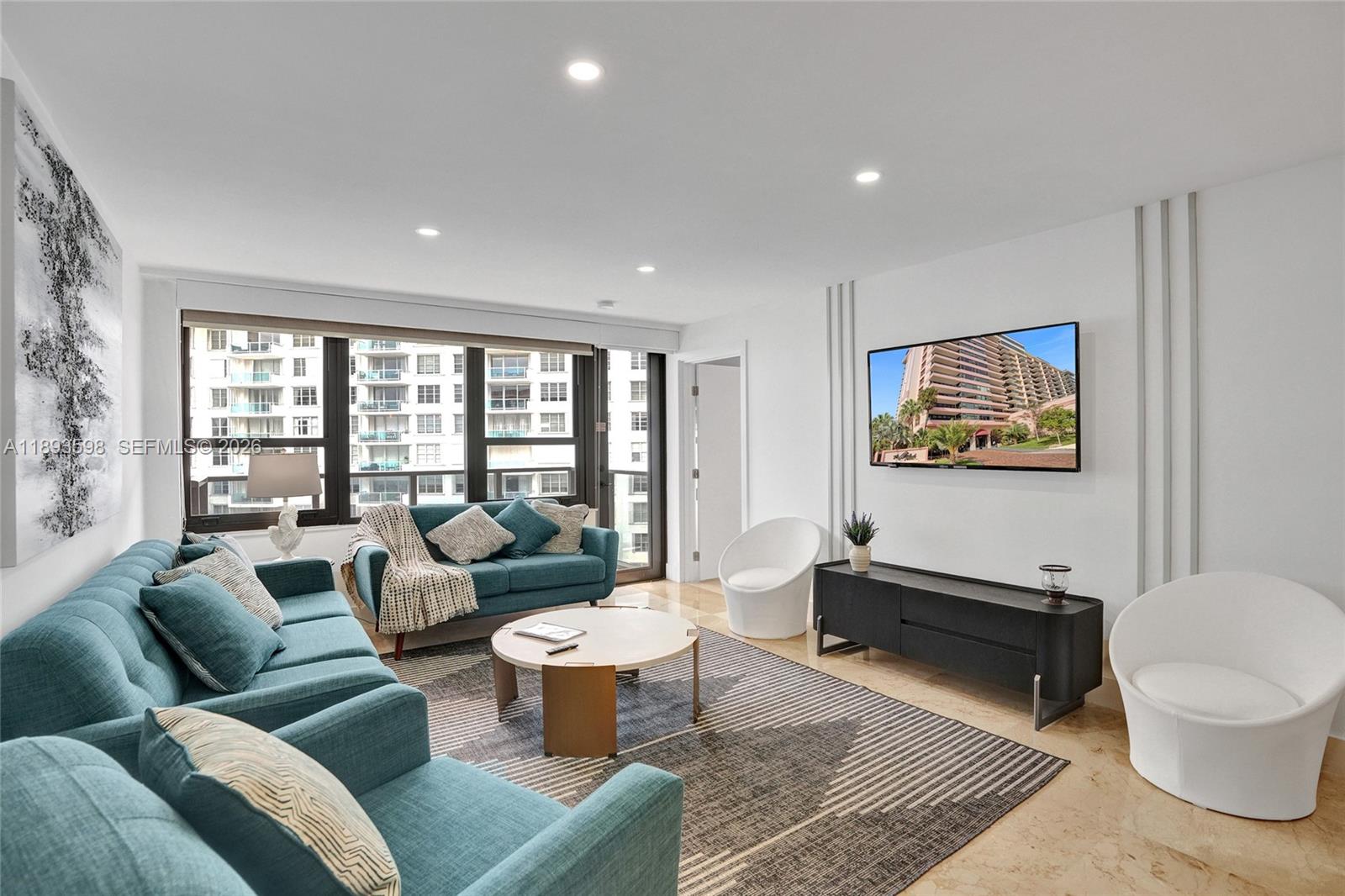 5225 Collins Avenue, Unit 1411 Miami Beach, FL 33140 - Photo 10 of 36 a living room with furniture a rug and a large window