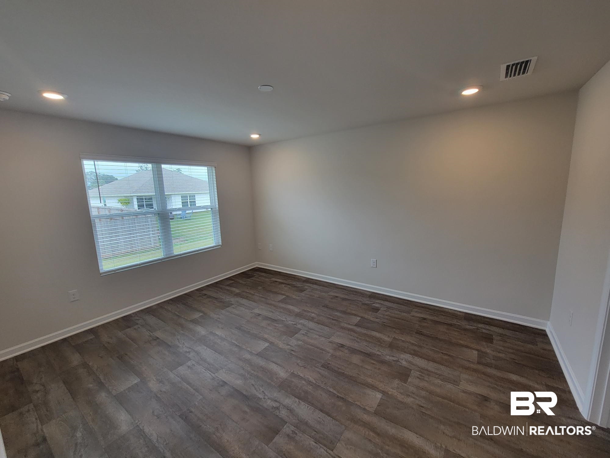 17099 REFLECTION Street Loxley, AL 36551 - Photo 17 of 29 Empty room featuring dark hardwood / wood-style flooring