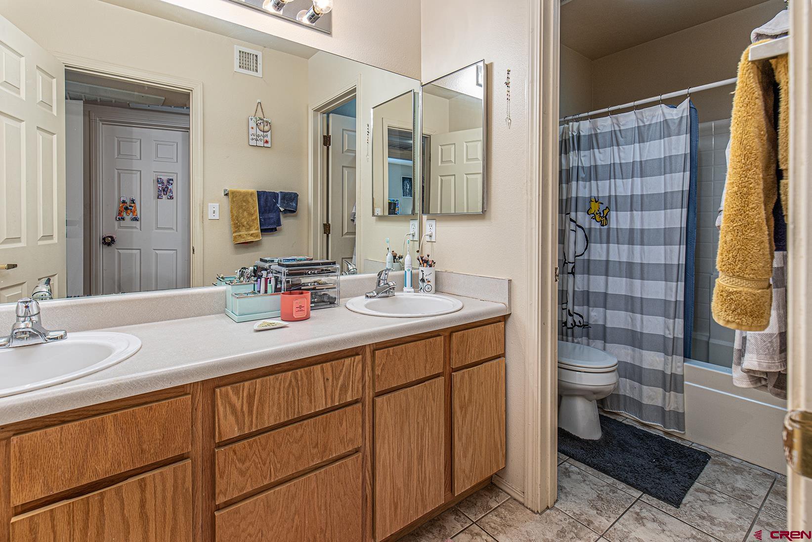 1100 Goeglein Gulch Road, Unit 170 Durango, CO 81301 - Photo 16 of 21 a bathroom with a double vanity sink toilet and shower
