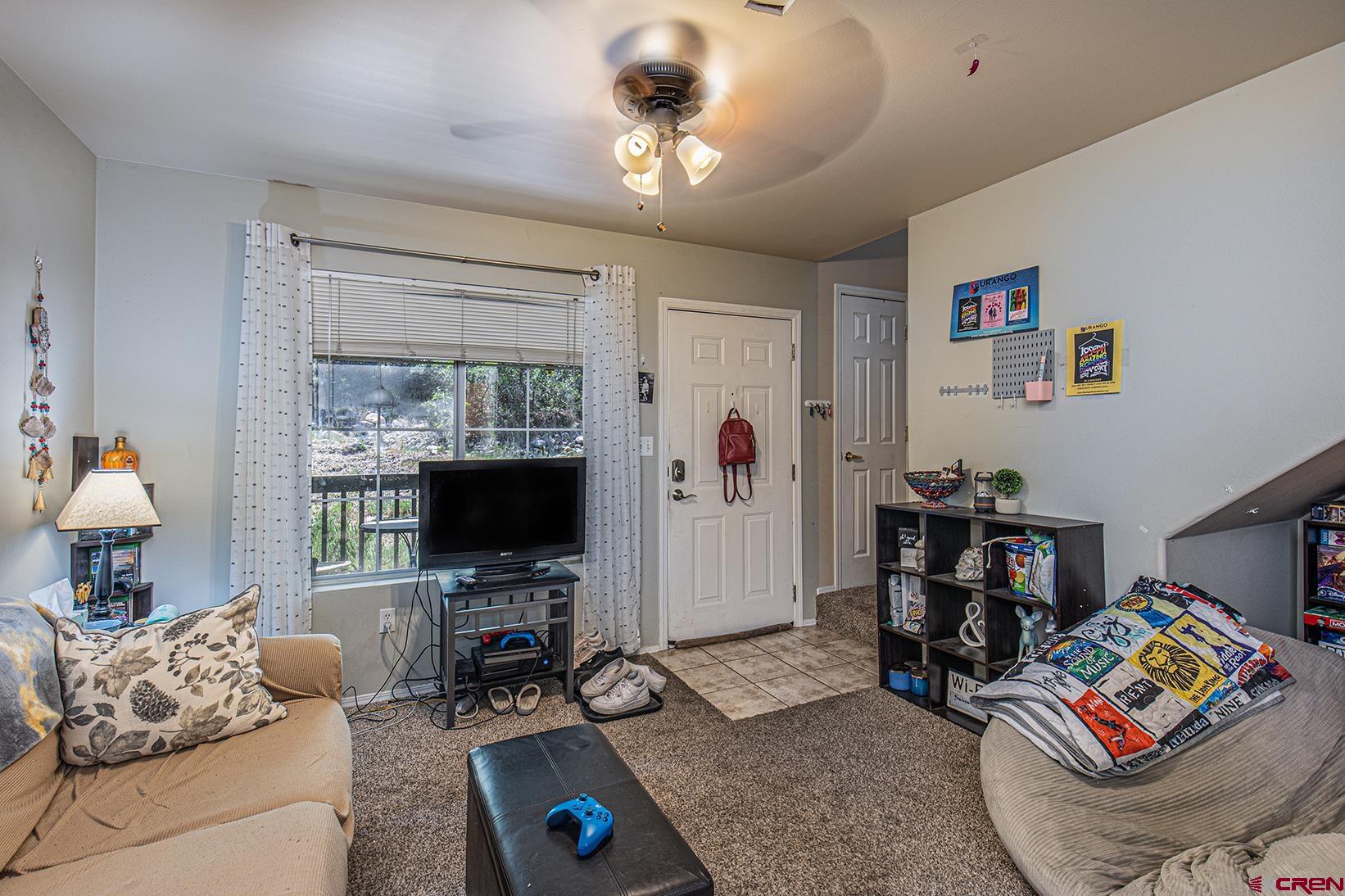 1100 Goeglein Gulch Road, Unit 170 Durango, CO 81301 - Photo 3 of 21 a living room with furniture and a flat screen tv