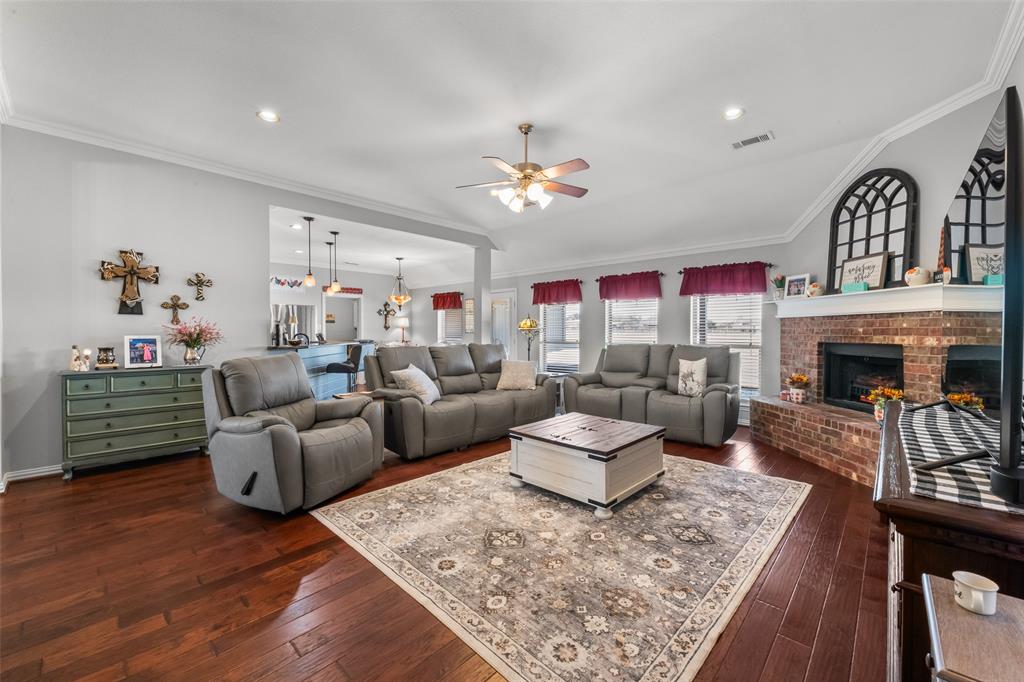 11277 Emerald Ranch Lane Forney, TX 75126 - Photo 11 of 32 a living room with fireplace furniture and a fireplace
