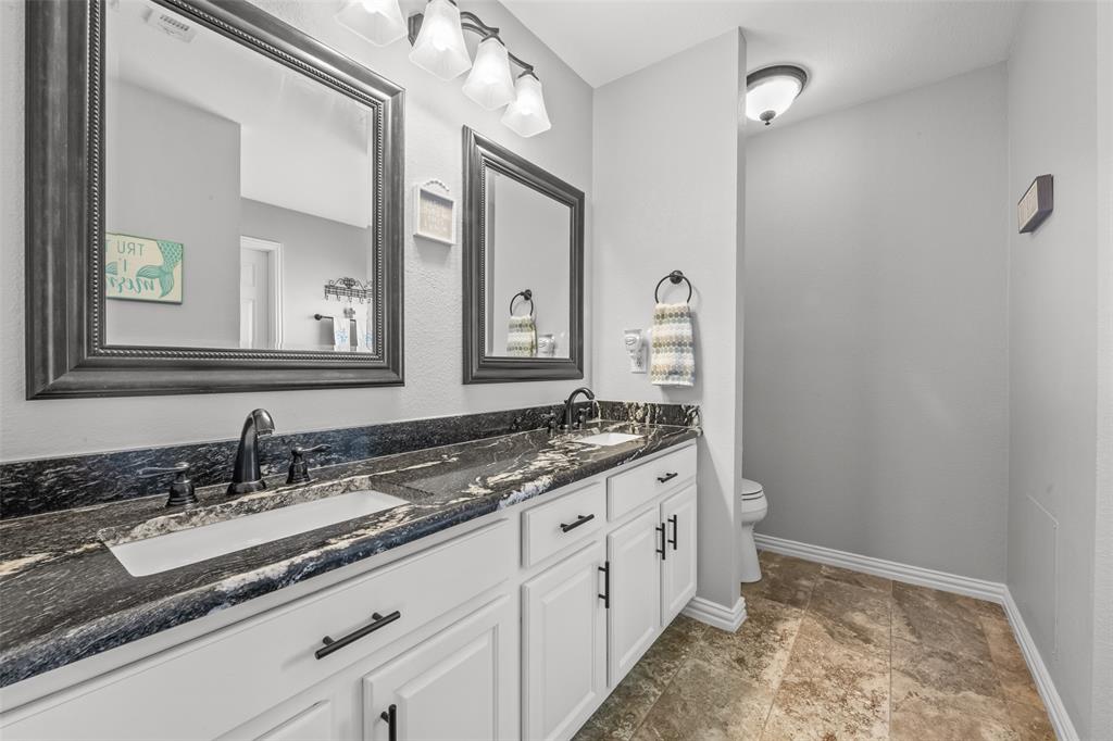 11277 Emerald Ranch Lane Forney, TX 75126 - Photo 17 of 32 a spacious bathroom with a granite countertop sink and a mirror