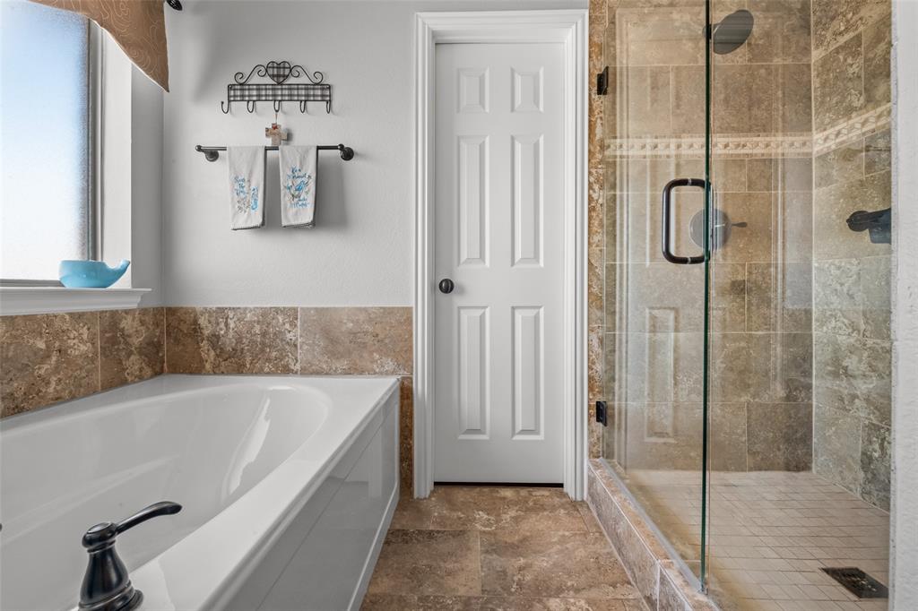 11277 Emerald Ranch Lane Forney, TX 75126 - Photo 18 of 32 a spacious bathroom with a bathtub and shower