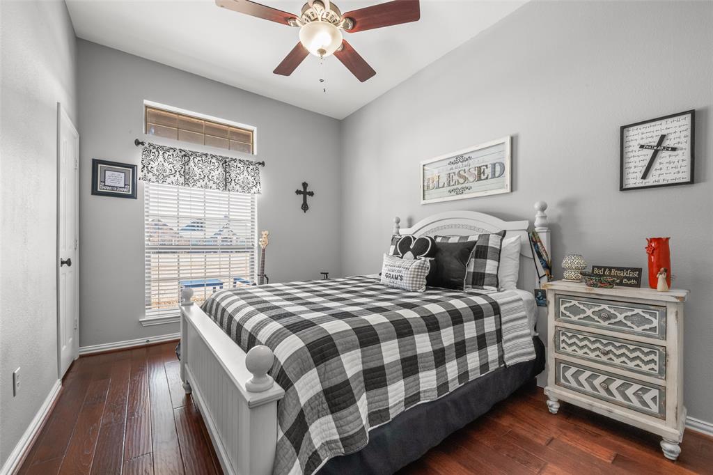 11277 Emerald Ranch Lane Forney, TX 75126 - Photo 19 of 32 a bedroom with a bed and wooden floor