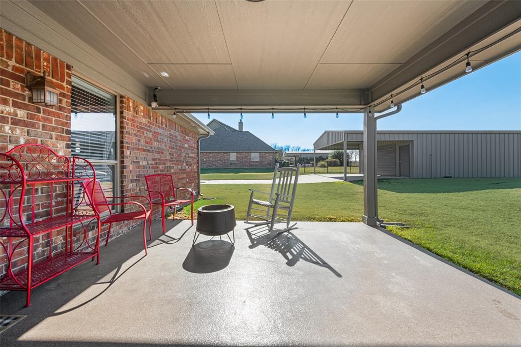 11277 Emerald Ranch Lane Forney, TX 75126 - Photo 24 of 32 a view of a patio with a table and chairs