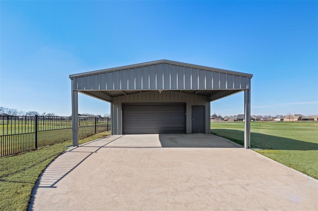 11277 Emerald Ranch Lane Forney, TX 75126 - Photo 28 of 32 a front view of a house with a garden