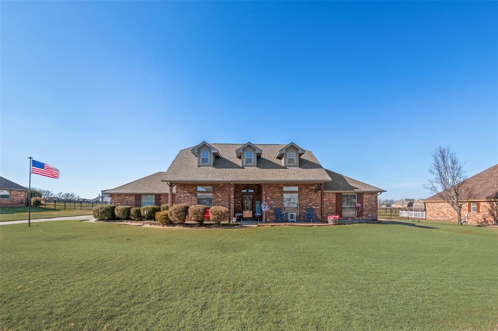 11277 Emerald Ranch Lane Forney, TX 75126 - Photo 3 of 32 a front view of a house with garden