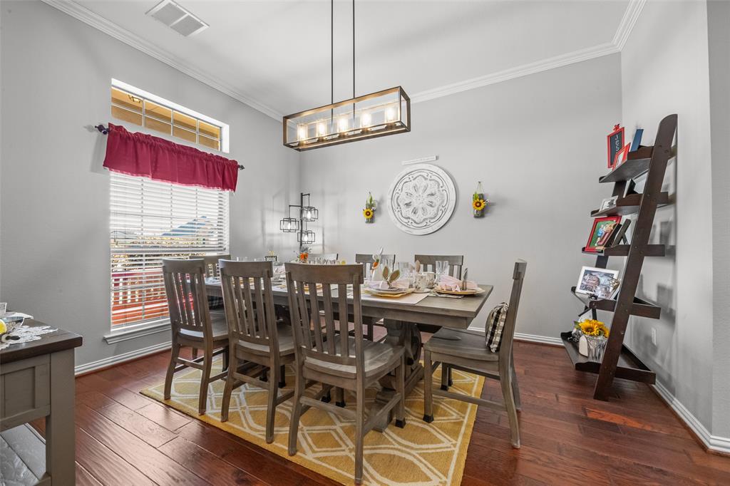 11277 Emerald Ranch Lane Forney, TX 75126 - Photo 6 of 32 a view of a dining room and livingroom with furniture wooden floor a chandelier