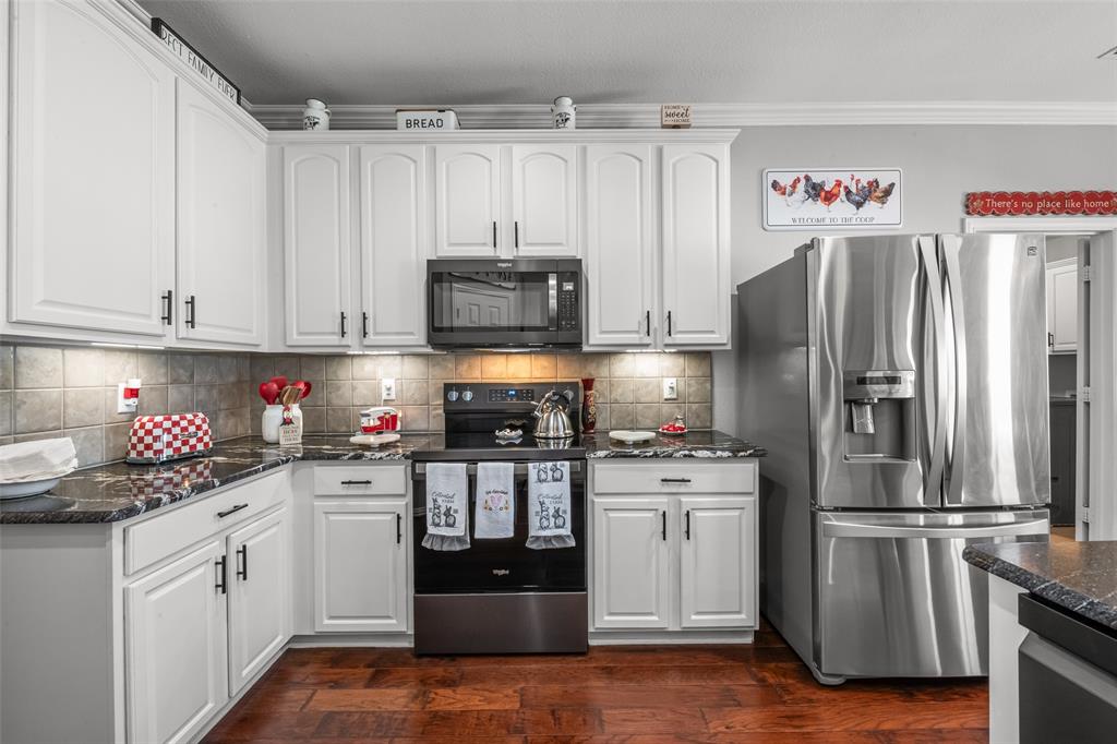 11277 Emerald Ranch Lane Forney, TX 75126 - Photo 9 of 32 a kitchen with a sink stainless steel appliances and cabinets