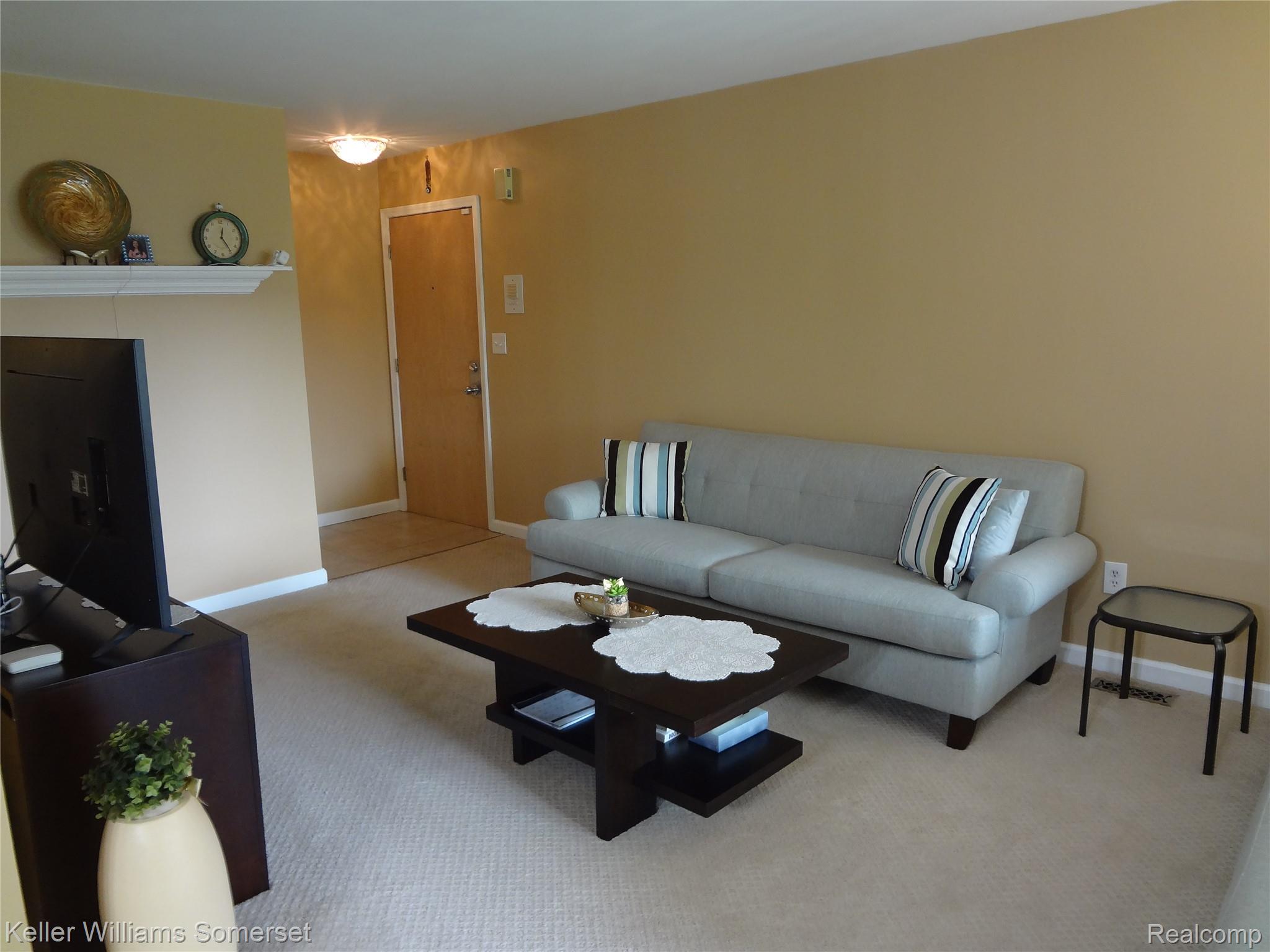 29626 Hoover Road, Unit 626 Warren, MI 48093 - Photo 3 of 35 Carpeted living room featuring baseboards