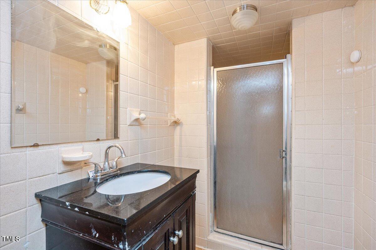 2540 Mayo Lake Road Roxboro, NC 27574 - Photo 19 of 24 a bathroom with a sink and a mirror