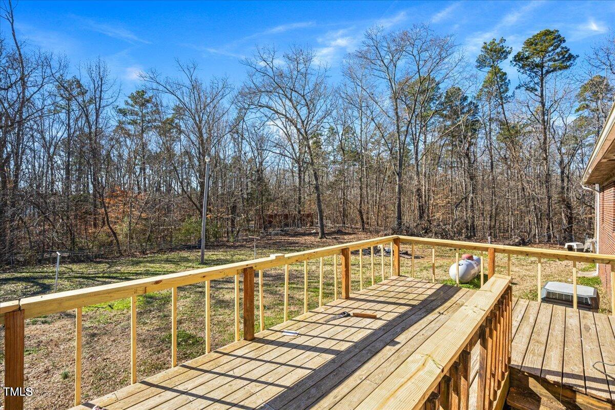 2540 Mayo Lake Road Roxboro, NC 27574 - Photo 20 of 24 a view of a balcony with wooden floor and outdoor seating