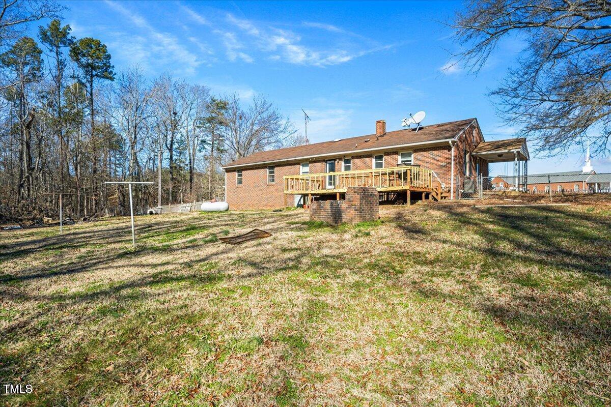 2540 Mayo Lake Road Roxboro, NC 27574 - Photo 23 of 24 a view of a house with backyard and trees