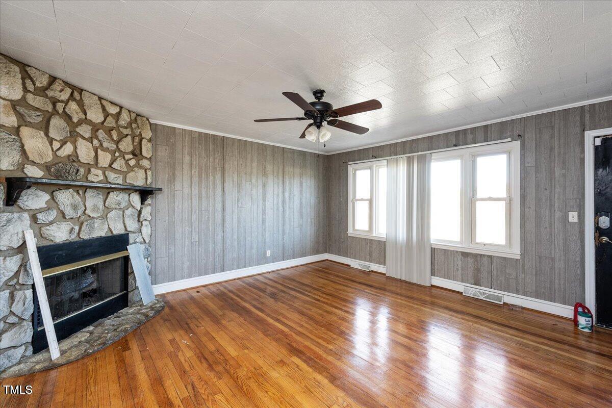 2540 Mayo Lake Road Roxboro, NC 27574 - Photo 7 of 24 a view of an empty room with a fireplace and a window