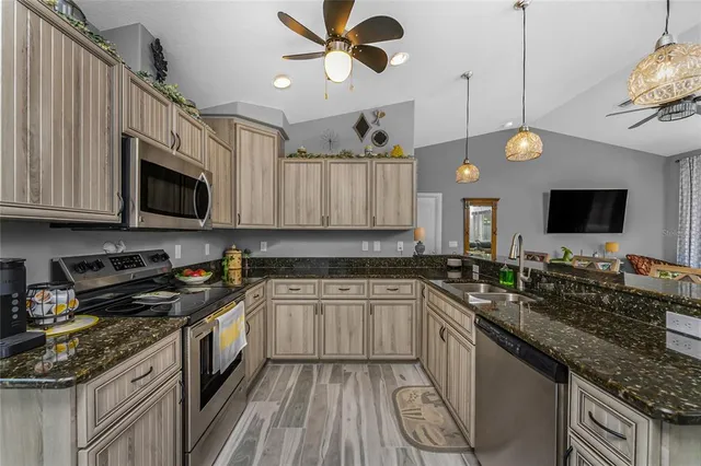 a kitchen with a sink stove and microwave