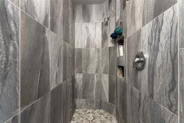 a view of walk in closet with clothes